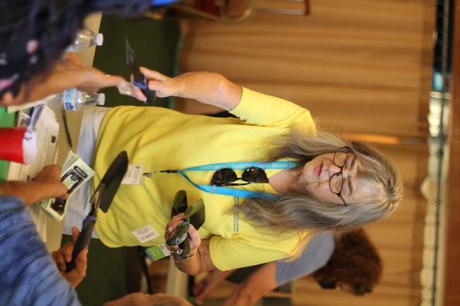 Ana Peeks, UC Master Gardener of Orange County, gives participants trowels for their home gardens.