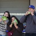 Students from Fullerton Joint Union High School, including Andres Martinez (right), snack on lettuce grown in hydroponics at the South Coast REC. Photo by Saoimanu Sope.