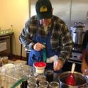 John Watkins, a UC Master Food Preserver and Master Gardener in the Bay Area, loads black beans into a jar to be pressure canned