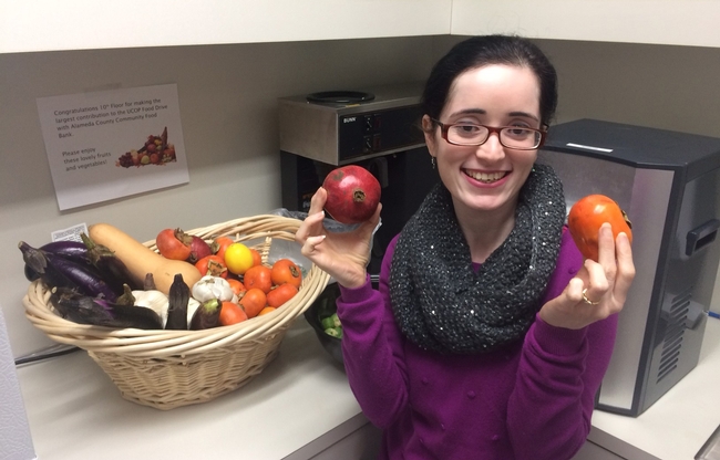 Ruchi Kashyap shows some of the fruits and vegetables in the $100 farmers market basket.
