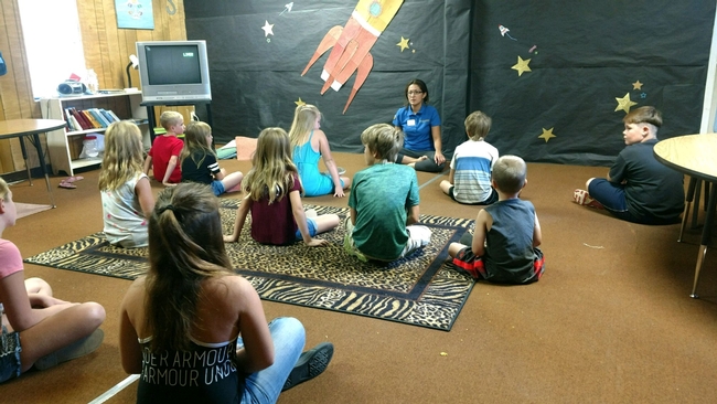 UC ANR staff member Margarita Alvord leads a yoga class with Trinity County youth.