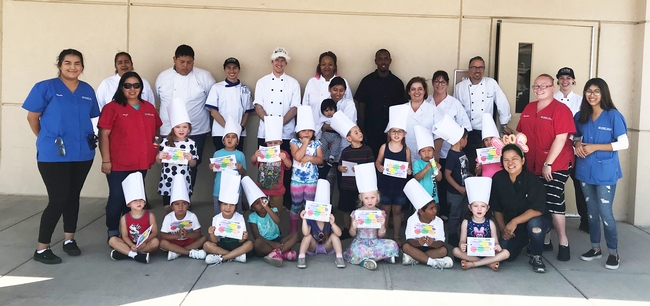 Community college student teachers with Preschoolers who received a certificate and chef's hat