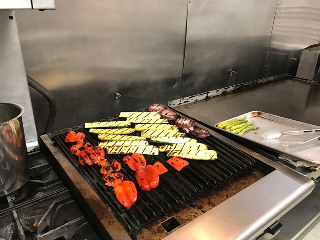 The colorful grilled vegetables on the stove top.