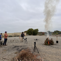 Research staff from UC Riverside and UC Irvine observe a dried shrub burning at the South Coast Research and Extension Center in May 2023. All photos by Saoimanu Sope.