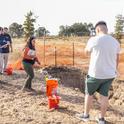 Professor Elizabeth Mosqueda (in orange shirt) instructs her students at the soil pit in the Master Gardeners' Three Sisters Garden. (Photos: Sarah Del Pozo)