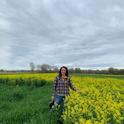 Sarah Light, standing in a field of white mustard cover crop, will discuss research on the benefits and challenges of growing cover crops.
