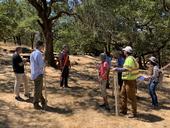 Forestry advisor talks with a workshop group in an oak woodland