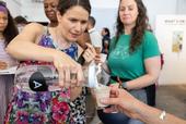 Edith de Guzman pours a sample of water for a taste test