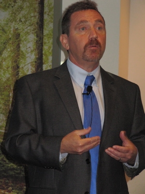 Close-up of Santer talking with hands moving