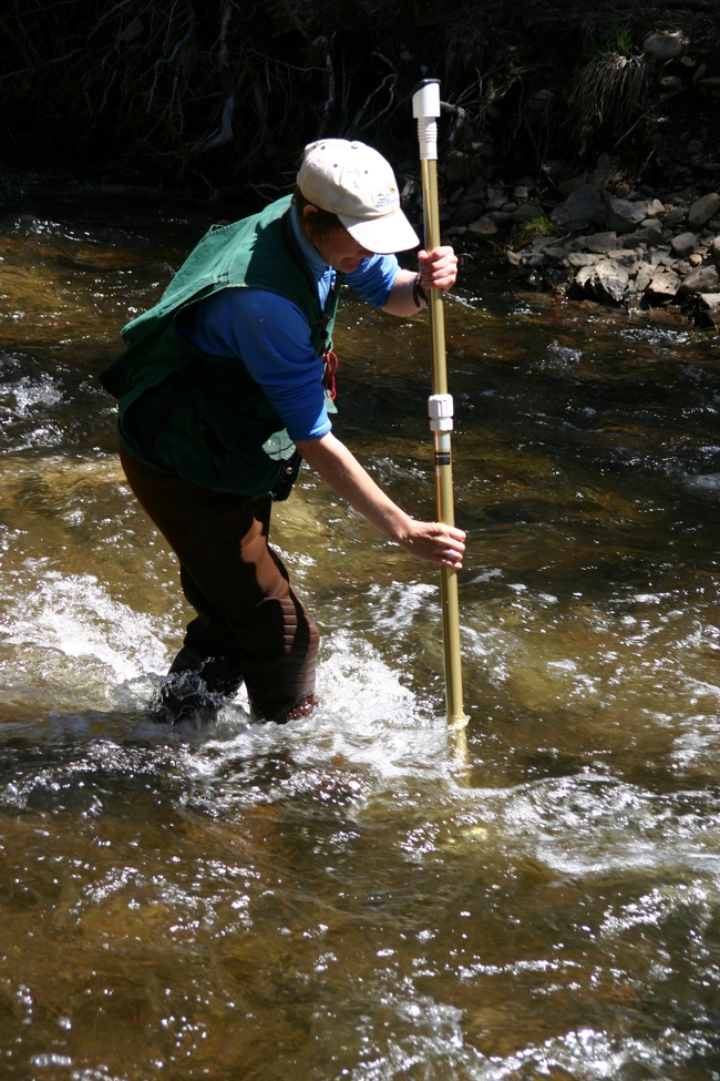Bobette Jones collecting stream flow measurements.