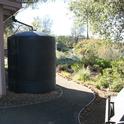 A foothill dwelling landscaped with a five-foot non-combustible zone. The building is also equipped with an extra large rain barrell that collects water during storms for irrigating plants.