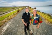Professors and Delta Independent Science Board members Vincent Resh (right) and Richard Norgaard stand on a levee on Sherman Island along the Sacramento River.