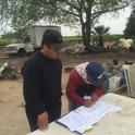 Xia Chang works with a Hmong farmer on making changes to energy billing.