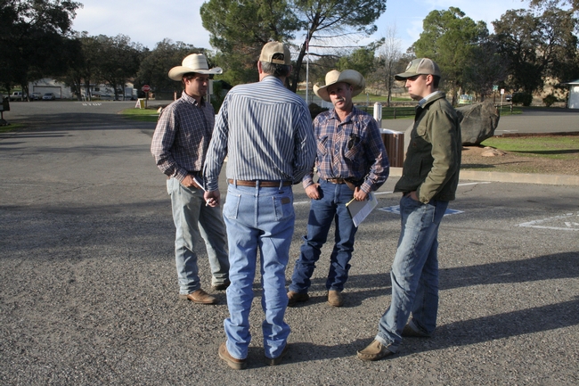 Ranchers confer after the Mariposa meeting.