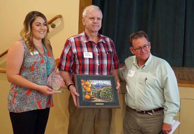 The Citrus Research Board presented UCCE specialist Joe Morse, center, with a specially comissioned painting at the Exeter meeting in honor of Morse's retirement June 30 following a 36 year entomology research career at UC Riverside.