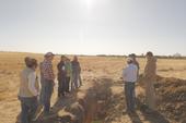 Participants gather around the first soil pit of the field tour, as Toby O'Geen provides a brief natural history of the land.
