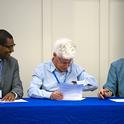 From left, Ermias Kebreab, Eli Feinerman and Mark Bell sign agreement for Israel and California scientists to collaborate more on water-related research and education.