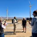 Cameron Barrows interviews Randy Buckmaster for the Climate Stewards Palm Springs windmill tour. Colin Barrows and Tracy Bartlett shoot video for the virtual field trip. Photo by Elizabeth Ogren Erikson