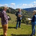 A Sonoma County property owner, center, discusses reducing fire hazards on his land by Lake Sonoma with Stephanie Larson, UC Cooperative Extension director in Sonoma County, and Mike Jones, UCCE forestry advisor.