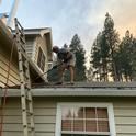 One of the most important tasks for wildfire preparedness is clearing the roof of debris. UC ANR photo