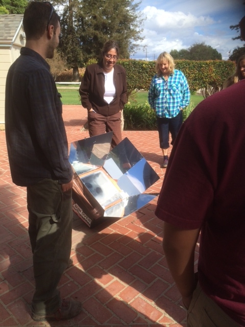 Alternative energy--observing solar oven at work making brownies