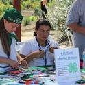 Community service table. 4-H youth participate in a card making table for service men and women.