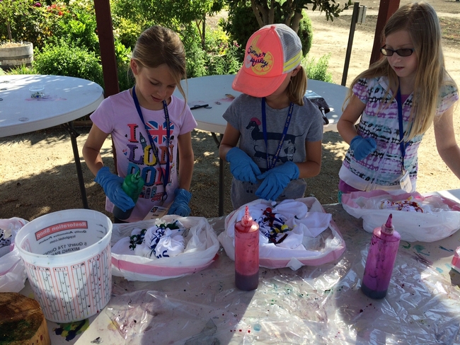 Tie dying camp shirts is a group bonding activity and lots of FUN!
