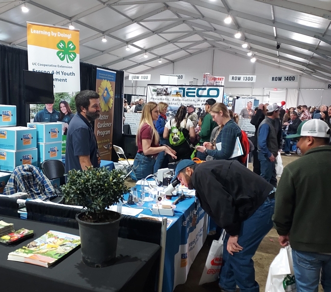 SRAs Brady Holder and Lauren Vuicich provide information from the Kearney booth at World Ag Expo.