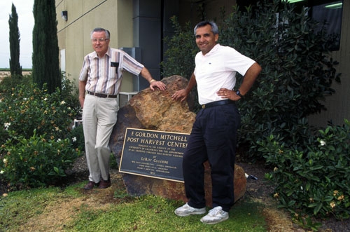 Gordon Mitchell (left) with post harvest scientist Carlos Crisosto in front of the F. Gordon Mitchell Postharvest Center at Kearney.