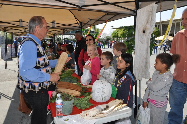 Richard Molinar displaying Southeast Asian vegetables and discussing Southeast Asian culture with students attending the Fresno Farm and Nutrition Day (photo by Fresno Farm Bureau).