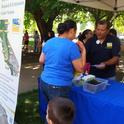 Rodolfo Cisneros sharing information about Kearney with a local resident at the 2014 Parlier Earth Day.