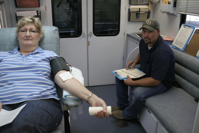Staff research associate Sue Collin (left) and physical plant mechanic Patrick West prepare to donate.