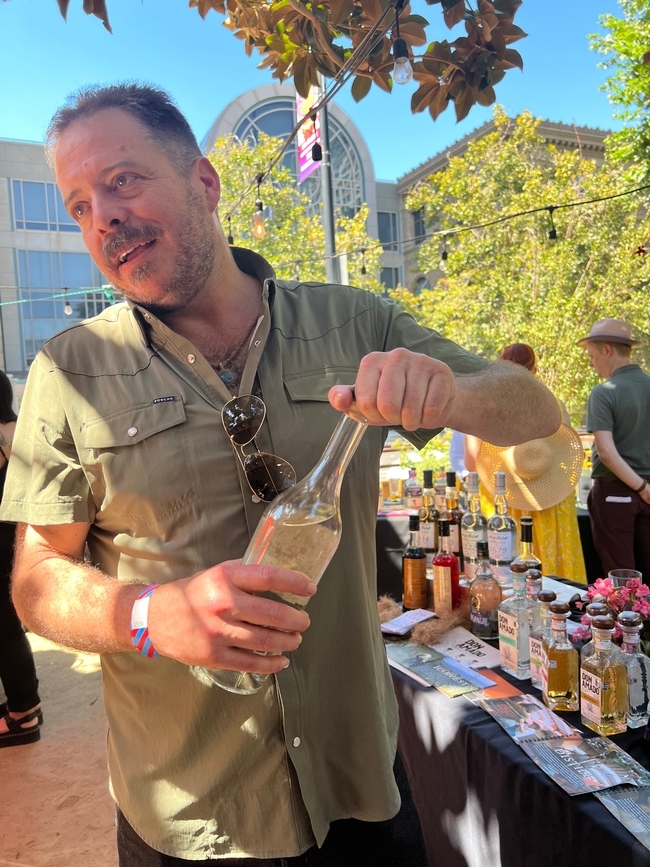 An agave grower and spirits importer shows off a favorite bottle of mezcal
