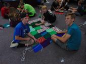 Three 4-H youth work together to assemble a blanket