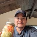 Kit Leung showing vegetables he grew and pickled Vietnamese style.