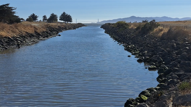 Receiving water flowing out towards San Francisco Bay with Golden Gate Bridge in the distance.