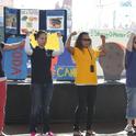 The UC Calfresh Nutrtion staff flexs their muscles as they teach kids the importance of eating all 5 food groups from MyPlate.