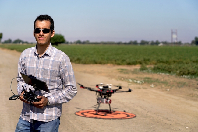 Photo 5: Ph.D. student Mohammadreza Narimani with a drone used to fly over a research field in Woodland as part of research into the parasitic weed Orobanche ramosa. (Karin Higgins/UC Davis)