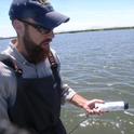 John Miskella holds a dissolved oxygen / temperature datasonde for use in the study.