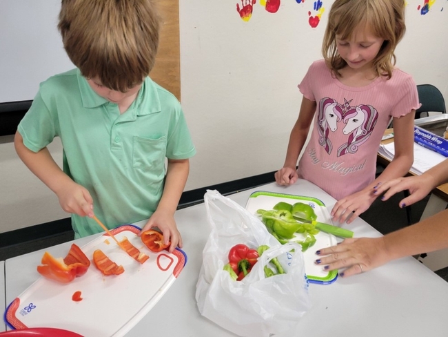 Children cutting veggies
