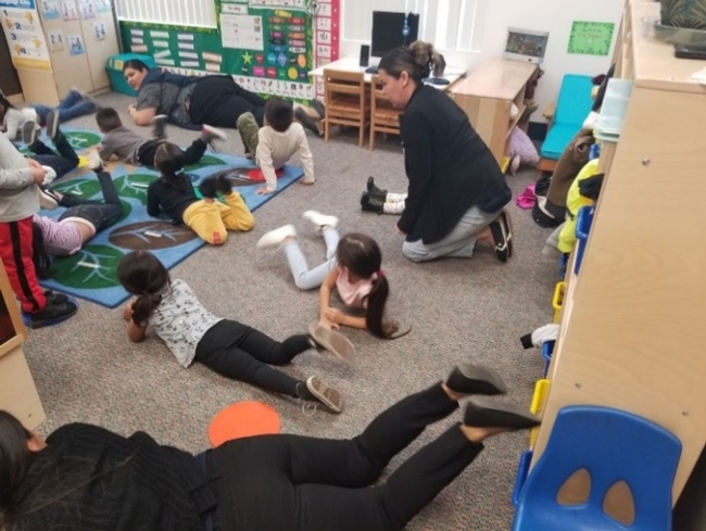 Students performing a CATCH ECE activity inside their classroom.