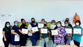 CAPSLO teachers stand in a line and hold their CATCH training certificate