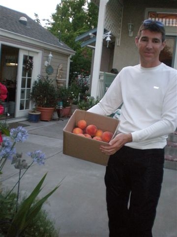 My son Joel with our peaches.