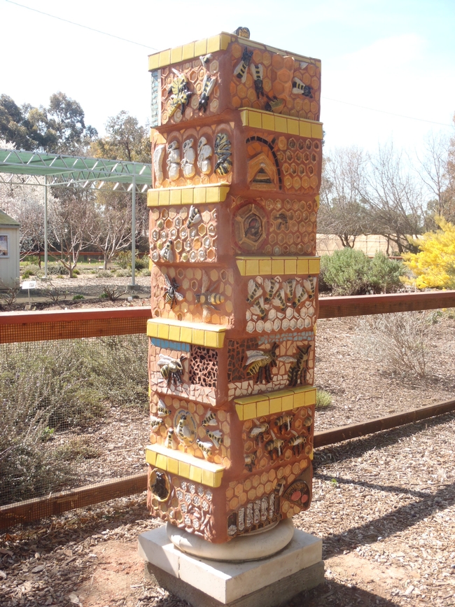 Pillar decorated with honey bee art.