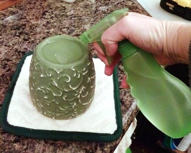 Spraying pot bottom to make a hole.