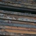 Lumber prior to processing - note the nails that all have to be removed by hand
