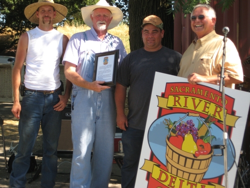 members of Sacramento River Delta Agritourism Association with sign