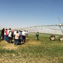 Twilight Field Day participants view a center pivot irrigation system.