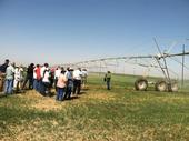 Twilight Field Day participants view a center pivot irrigation system.