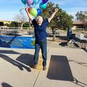 Nancy Caywood-Robertson jumps off a bale of hay at the UC Desert Research and Extension Center 'Farm Smart' celebration.